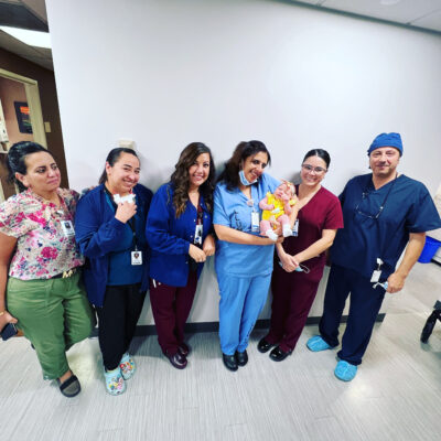 Baby Ava, born with assisted reproductive technology, and her mom, Amy, visiting with Dr. Bareh and staff | LLU Center for Fertility & IVF | Loma Linda, CA