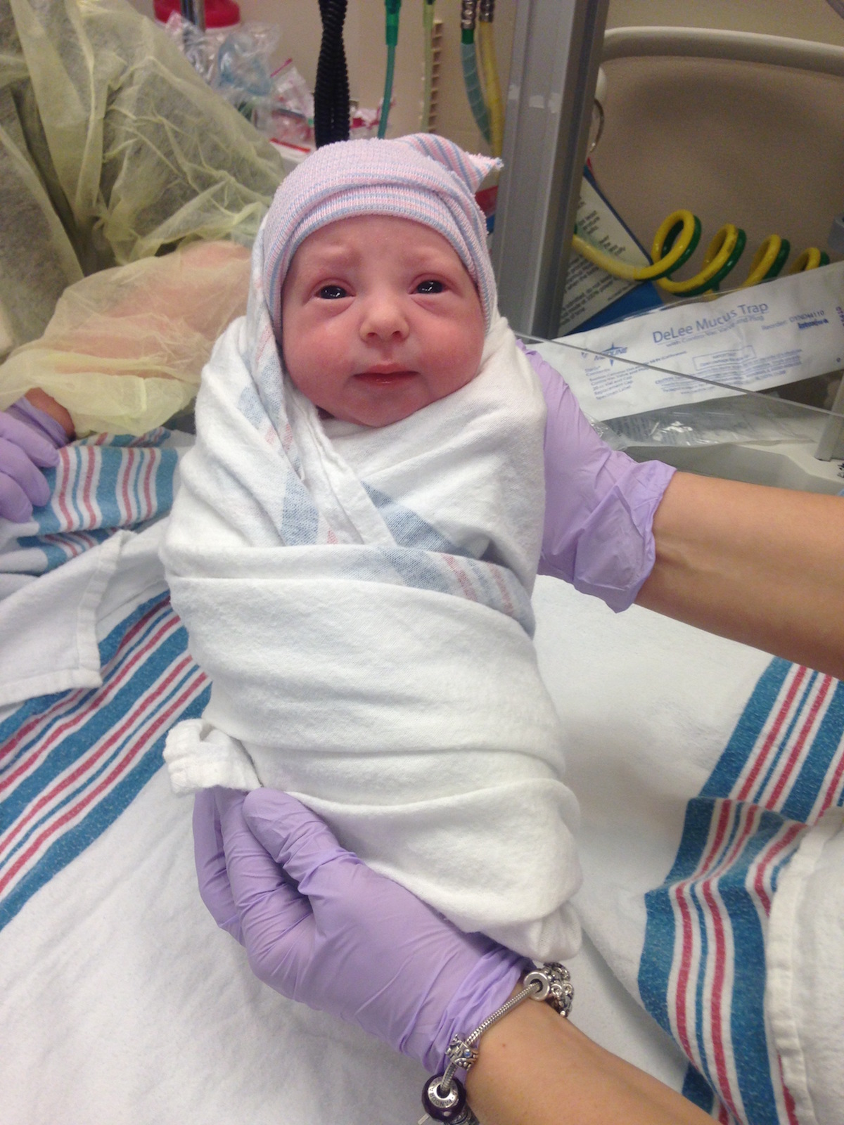 IVF | LLU Center for Fertility and IVF | Baby Kate swaddled in white and purple